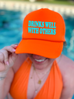 Drinks Well With Others Trucker Hat